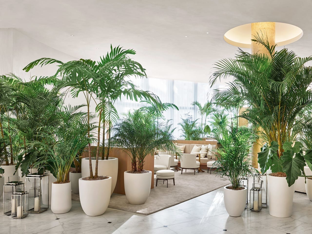 Bright white lounge and tropical greenery at The Miami Beach EDITION